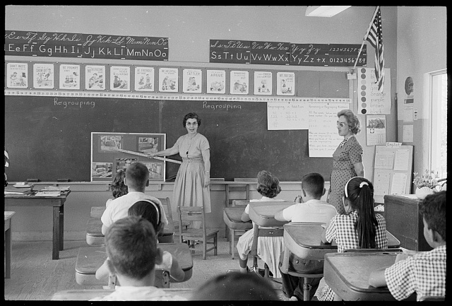 loc-Cuban-refugee-students-in-a-classroom-with-a-teacher-standing-in-front-of-a-.jpg