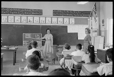 loc-Cuban-refugee-students-in-a-classroom-with-a-teacher-standing-in-front-of-a-.jpg