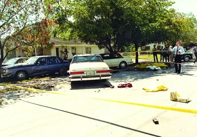 Crime_scene_photo_of_the_FBI_Miami_shootout__showing_suspect_and_agents__vehicles_and_battle_debris._Photo_by_Miami-Dade_PD.jpg