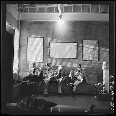 Navy_pilots_waiting_in_the_office_of_NATS_at_Miami__Florida_for_transportation_to_Trinidad__B.W.I._-_NARA_-_520699.jpg